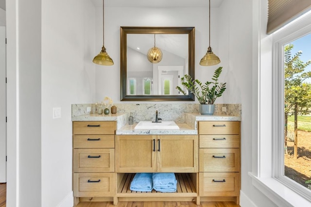 bathroom with lofted ceiling and vanity