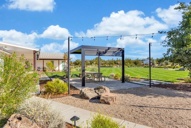 view of home's community with a patio and a lawn