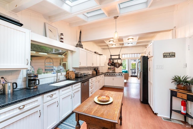 12130 Hwy 116, Guerneville, CA 95446 - kitchen with a sink, coffered ceiling, tasteful backsplash, appliances with stainless steel finishes, and light wood-type flooring