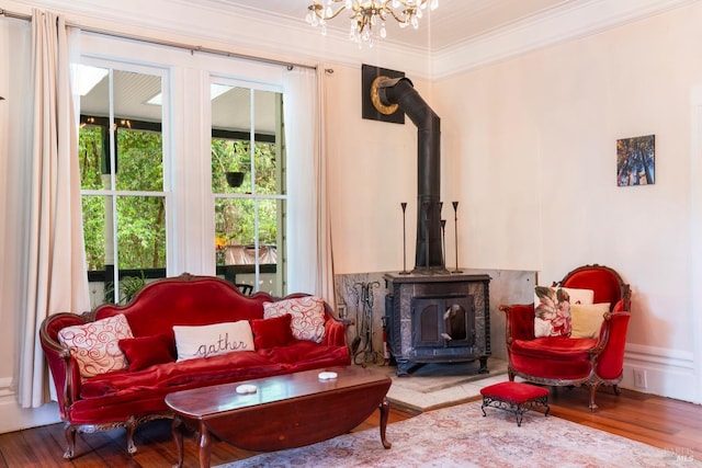 12130 Hwy 116, Guerneville, CA 95446 - living area with a wood stove, ornamental molding, wood finished floors, and a chandelier