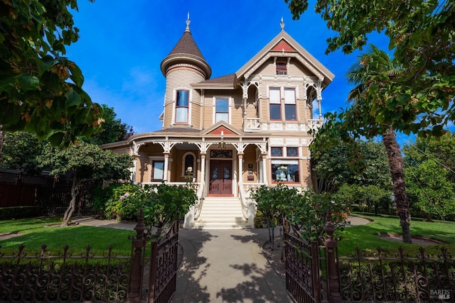 victorian home featuring a front yard and a porch