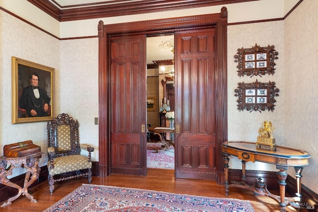 foyer with ornamental molding and hardwood / wood-style floors