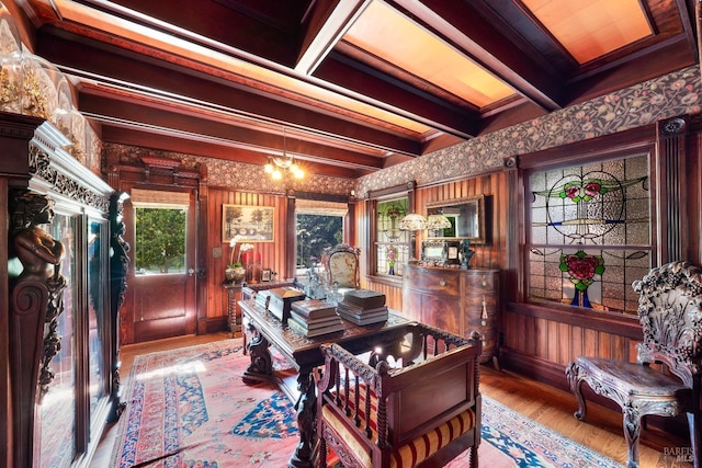 interior space featuring wood-type flooring, beam ceiling, a chandelier, and crown molding