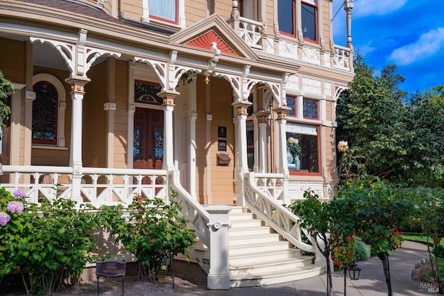 view of exterior entry with a porch