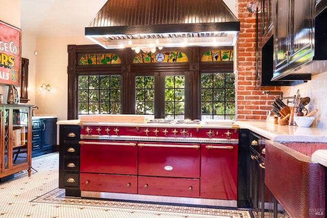 bar with wall chimney range hood and tasteful backsplash