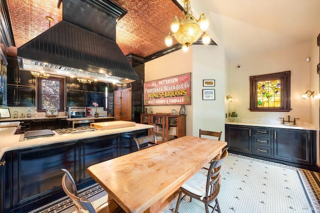 dining space with ornamental molding, sink, and high vaulted ceiling