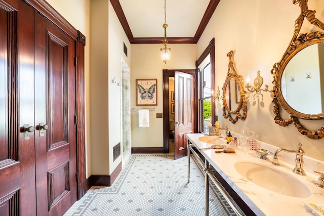 bathroom featuring tile patterned flooring, vanity, and crown molding