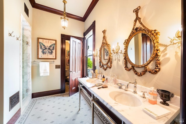 bathroom with ornamental molding, tile patterned flooring, a shower with shower door, and vanity