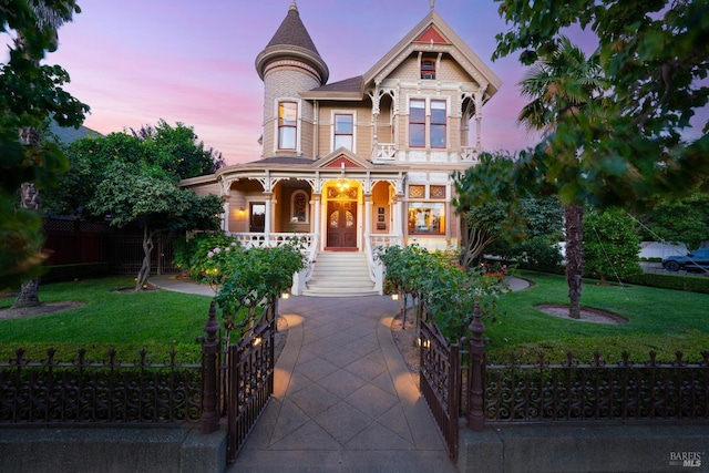 victorian home featuring a yard and covered porch