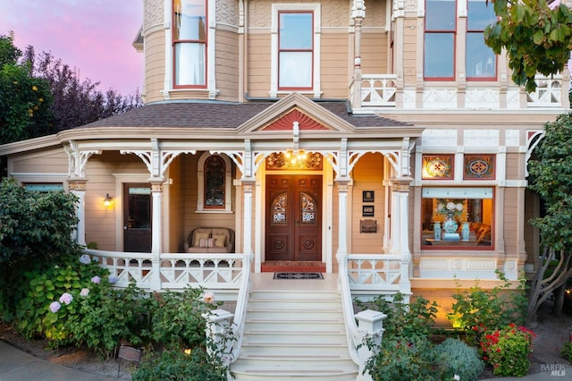 exterior entry at dusk with a porch