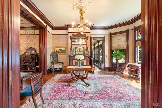 living area featuring wood-type flooring, crown molding, and a chandelier