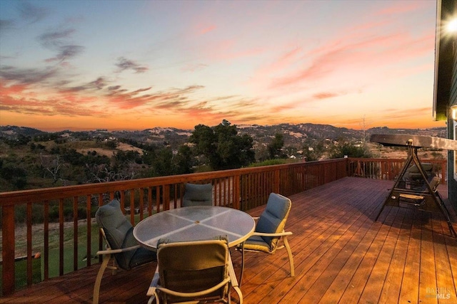 wooden terrace with outdoor dining space