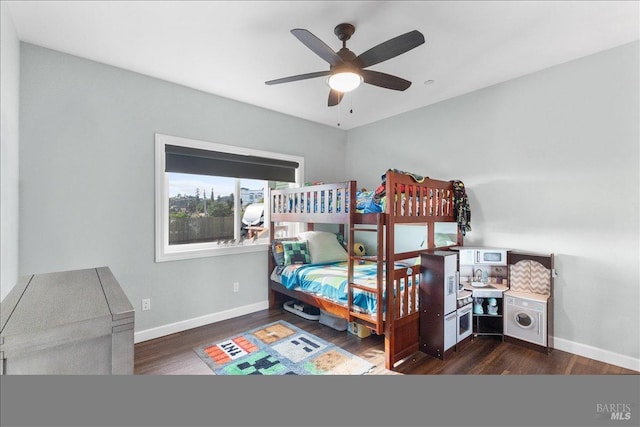 bedroom with a ceiling fan, baseboards, and wood finished floors