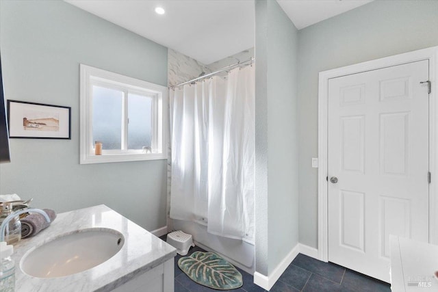 full bath with tile patterned flooring, shower / bath combo, baseboards, and vanity