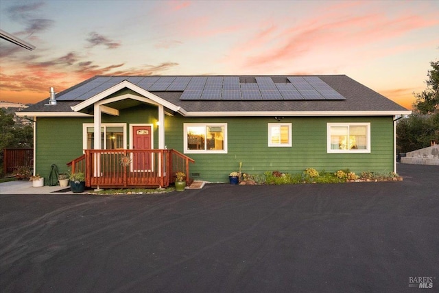 view of front of property with roof mounted solar panels