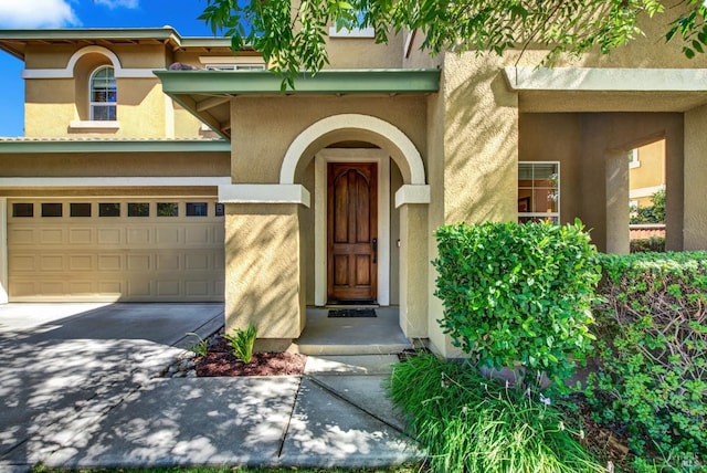 doorway to property with a garage