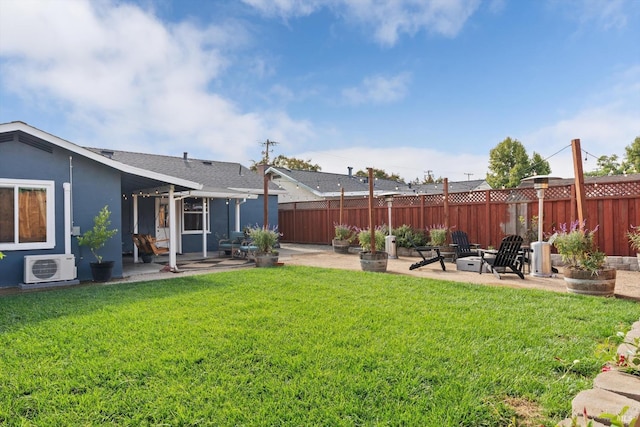 view of yard featuring a fire pit, ac unit, and a patio area