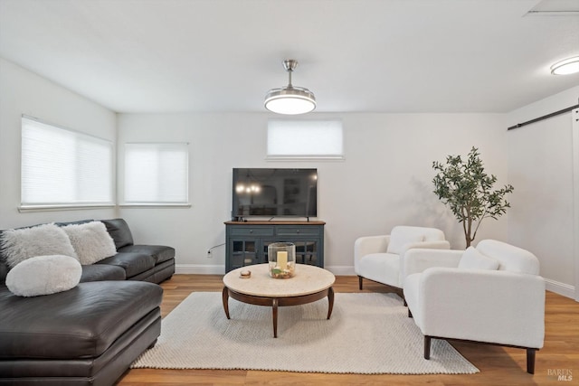 living room featuring hardwood / wood-style flooring and a barn door