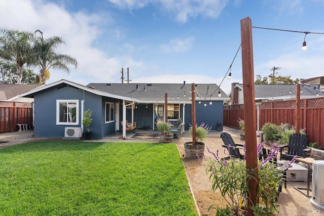 back of house with a yard and a patio