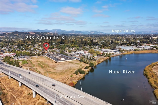 drone / aerial view featuring a water and mountain view