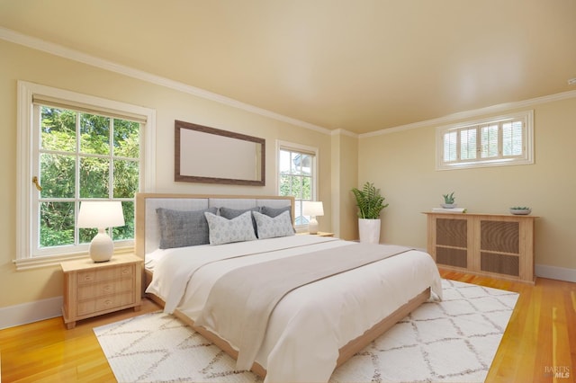 bedroom featuring ornamental molding and light hardwood / wood-style floors