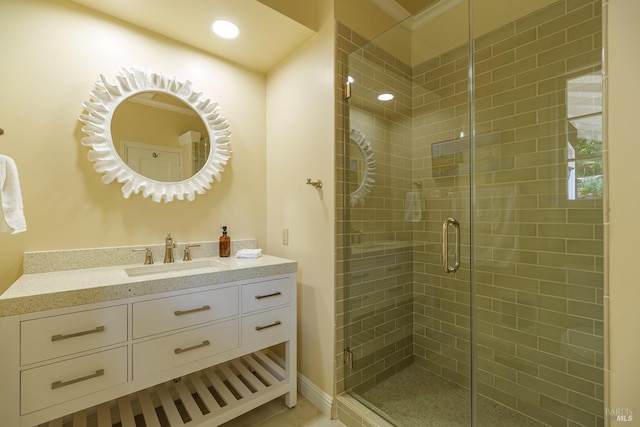 bathroom featuring an enclosed shower and vanity