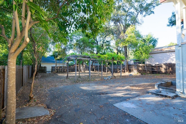 view of yard featuring a fenced backyard and a pergola