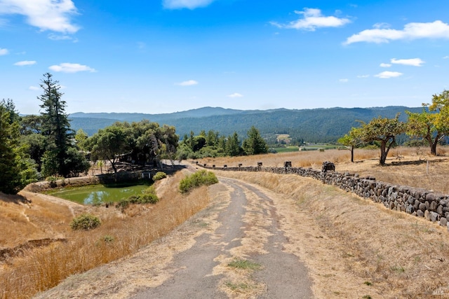 property view of mountains with a water view and a rural view