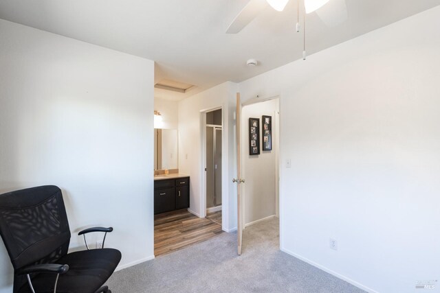 living area featuring light carpet and ceiling fan