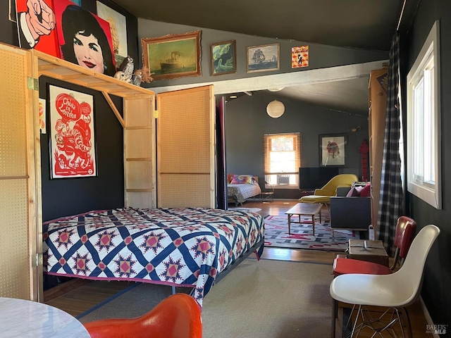 bedroom featuring wood-type flooring and lofted ceiling