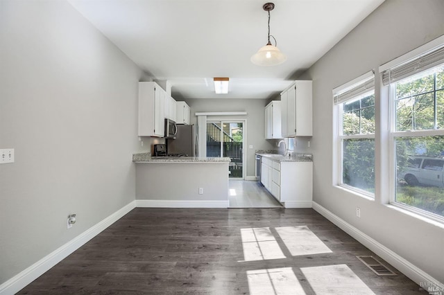 kitchen featuring a healthy amount of sunlight, dark hardwood / wood-style floors, and white cabinetry