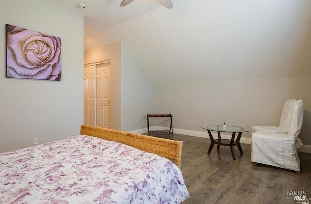 bedroom with dark wood-type flooring, a closet, and vaulted ceiling