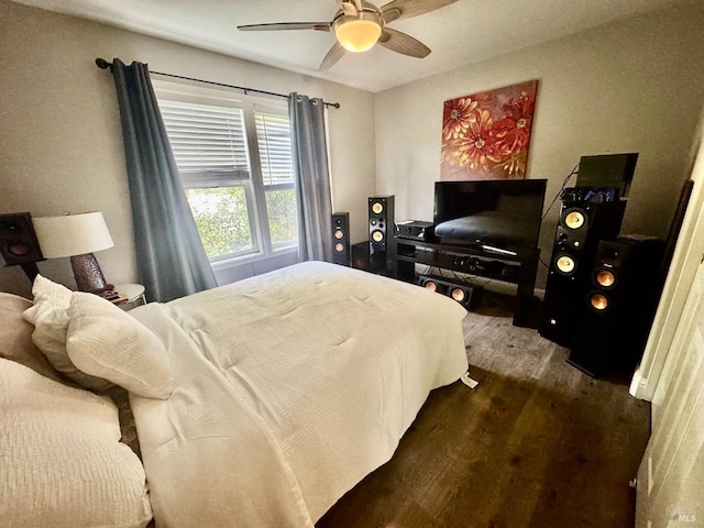 bedroom with ceiling fan and dark hardwood / wood-style flooring