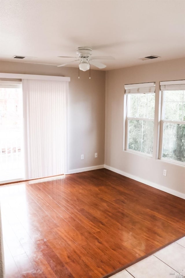 unfurnished room with ceiling fan and wood-type flooring