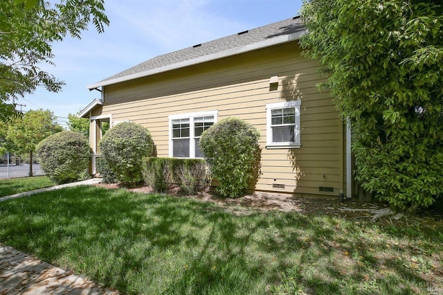 view of property exterior featuring a lawn