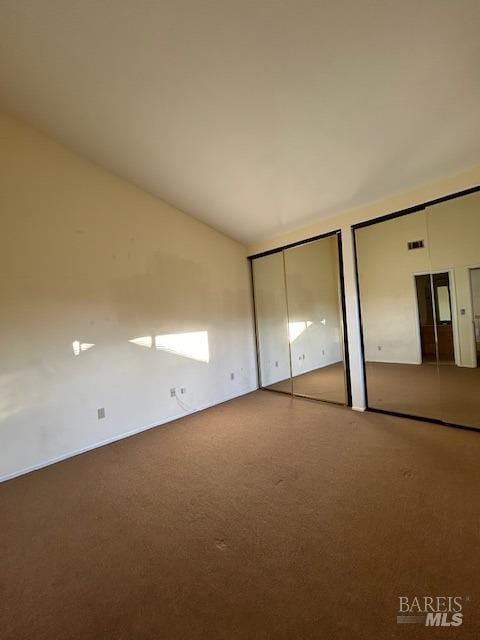 unfurnished bedroom featuring multiple closets