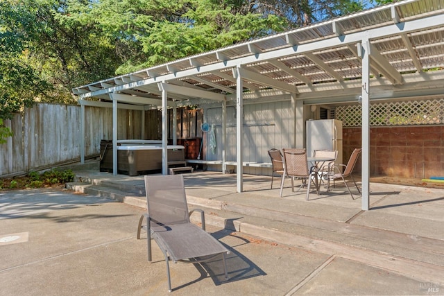 view of patio / terrace featuring a hot tub and a pergola