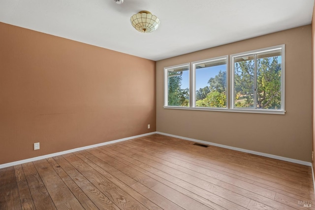 empty room featuring hardwood / wood-style flooring