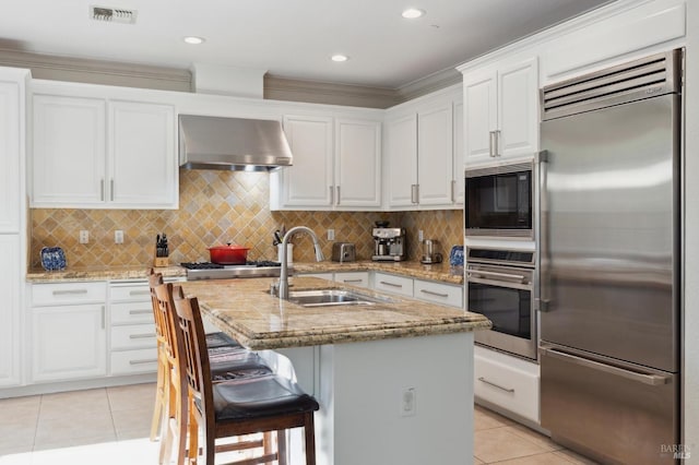 7 Oak Grove Dr, Novato, CA 94949 - kitchen with light tile patterned floors, a sink, built in appliances, visible vents, and wall chimney exhaust hood