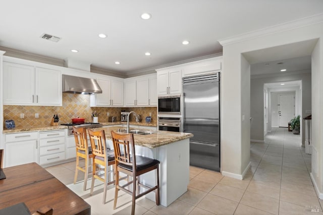 7 Oak Grove Dr, Novato, CA 94949 - kitchen with light tile patterned floors, wall chimney exhaust hood, a sink, and built in appliances