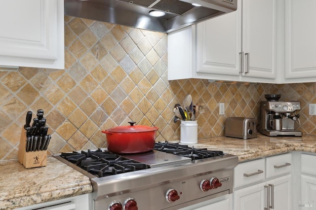 7 Oak Grove Dr, Novato, CA 94949 - kitchen with light stone countertops, white cabinetry, under cabinet range hood, and tasteful backsplash