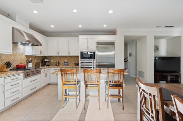 7 Oak Grove Dr, Novato, CA 94949 - kitchen with decorative backsplash, built in appliances, crown molding, wall chimney exhaust hood, and visible vents