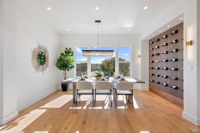 dining space featuring a chandelier and light wood-type flooring