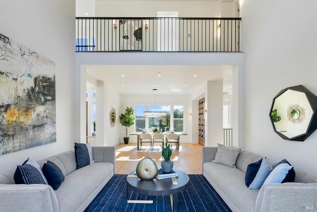 living room with wood-type flooring and a high ceiling