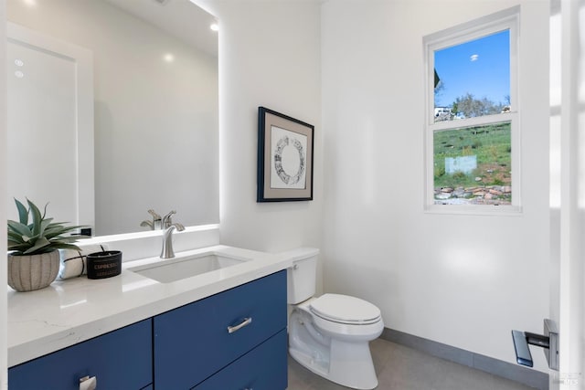 bathroom with tile patterned floors, vanity, and toilet