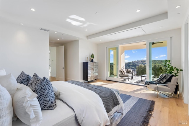 bedroom featuring light hardwood / wood-style floors and access to outside