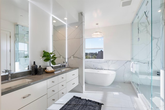 bathroom featuring tile patterned floors, vanity, tile walls, and shower with separate bathtub