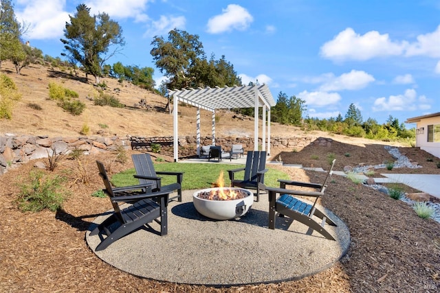 view of yard featuring a pergola, a patio, and a fire pit