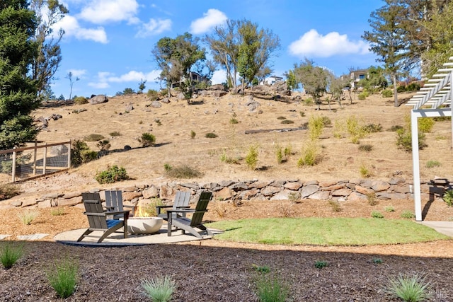 view of yard with an outdoor fire pit and a patio area