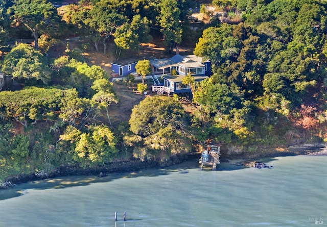 aerial view featuring a water view and a forest view